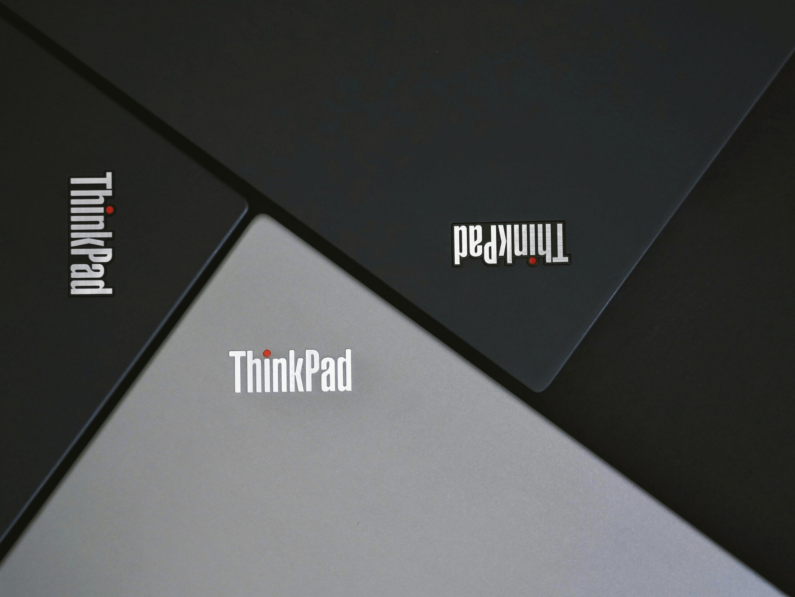 ThinkPad laptops arranged diagonally, forming geometric pattern
